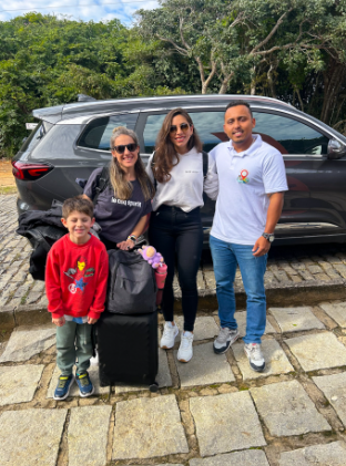 Família ao lado do veículo com suas bagagens
